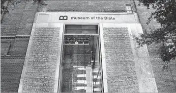  ?? MICHAEL S. WILLIAMSON/THE WASHINGTON POST ?? The entrance to the Museum of the Bible features relief metal lettering of Scriptures written backwards and in Latin.