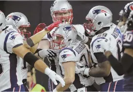  ?? AP PHOTOS ?? MIXED REVIEWS: Tom Brady (top) chats with Danny Amendola and Julian Edelman, and Rex Burkhead (above) is congratula­ted by teammates after scoring a touchdown in the second quarter of the Patriots’ 27-23 preseason loss to the Texans last night in Houston.