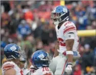  ?? THE ASSOCIATED PRESS ?? Giants running back Saquon Barkley, right, celebrates after scoring a touchdown against the Redskins on Sunday.