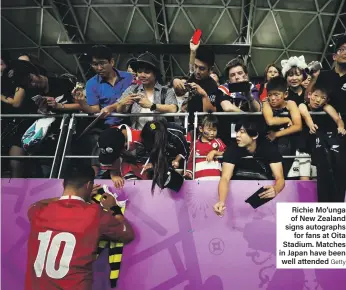  ?? Getty ?? Richie Mo’unga of New Zealand signs autographs for fans at Oita Stadium. Matches in Japan have been well attended