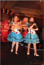  ?? Courtesy photo ?? Kids walk adoptable dogs on the runway at Rescues on the Runway’s “Head Over Heels for Rescues” fashion show fundraiser.