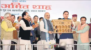  ?? HT PHOTO ?? Union home minister Amit Shah and chief minister Pushkar Singh Dhami at an event in Dehradun on Saturday.