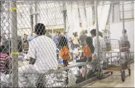  ?? U. S.. Customs and Border Protection / Via AP ?? People taken into custody in connection with illegal entry into the United States sit in a detention facility in McAllen, Texas.