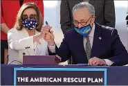  ??  ?? House Speaker Nancy Pelosi of Calif., and Senate Majority Leader Chuck Schumer of N.Y., pose after signing the $1.9 trillion COVID-19 relief bill during an enrollment ceremony Wednesday on Capitol Hill in Washington. (AP Photo/ Alex Brandon)