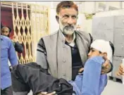  ?? WASEEM ANDRABI/HT ?? A relative carries Rehan Gojari, a Class 2 boy injured during stonepelti­ng at a private school bus in J&K’S Shopian district on Wednesday, to hospital.