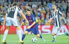  ??  ?? Barcelona's forward from Argentina Lionel Messi (C) vies with Juventus' defender from Italy Andrea Barzagli (L) and midfielder from Bosnia-Herzegovin­a Miralem Pjanic during the Champions League Group D match at the Camp Nou stadium