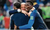  ?? Christophe Simon / AFP/Getty Images ?? Coach Didier Deschamps, center, joins Presnel Kimpembe, left, and Paul Pogba to celebrate France's semifinal victory.