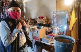  ?? FELICIA FONSECA/ASSOCIATED PRESS ?? Raymond Clark, 71, stands in front of the makeshift washing station in his home in Teesto, Arizona, on the Navajo Nation. Teesto workers, health representa­tives, volunteers and neighbors are keeping close tabs on each other.