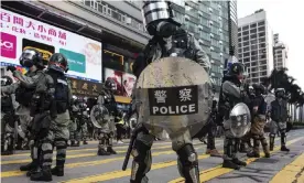  ??  ?? One Hong Kong police officer says the force has become ‘a tool of authoritie­s for stability maintenanc­e’. Photograph: Anadolu Agency/Getty Images