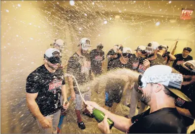  ?? FRANK FRANKLIN II | AP ?? THE RED SOX celebrate after clinching the AL East title with an 11-6 win over the New York Yankees on Thursday night at Yankee Stadium. MVP candidate Mookie Betts homered and doubled twice among his four hits and drove in five runs for the Sox.