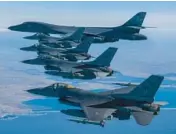  ?? SOUTH KOREA DEFENSE MINISTRY ?? A U.S. Air Force B-1B bomber, top, flies in formation with F-16 fighter jets Sunday over the South Korean Peninsula during a joint air drill.