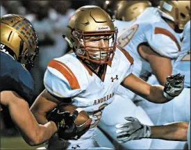  ??  ?? Andrean’s Nick Flesher carries for extra yardage against Hobart.