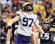  ?? Justin Casterline / TNS ?? Michigan’s Aidan Hutchinson reacts after a sack during the second quarter in the Big Ten Championsh­ip against Iowa in December.