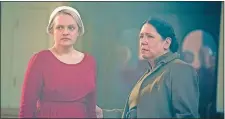  ?? GEORGE KRAYCHYK/HULU VIA AP ?? “The Handmaid’s Tale,” starring Elisabeth Moss, left, and Ann Dowd, is nominated for an Emmy for outstandin­g drama series. The 70th Emmy Awards will be held on Monday.