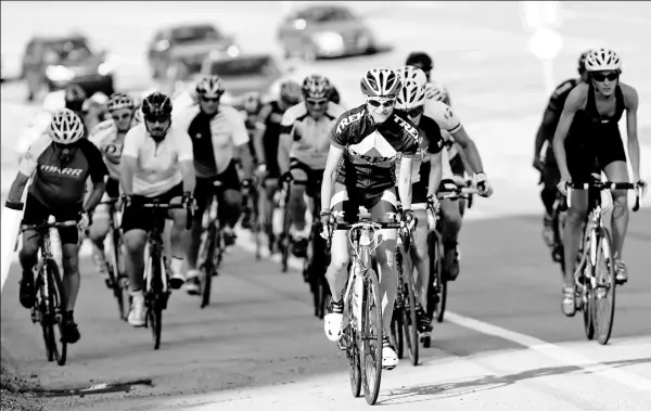  ?? John Heller/Post-Gazette photos ?? Members of the West Hills Road Riders climb a hill at Settlers Ridge in front of traffic. The club, founded five years ago, meets twice weekly for 25- to 30mile rides. For a video report of the club, go to www.post-gazette.com