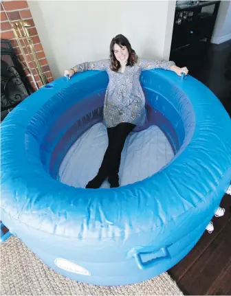  ??  ?? Ashley Brilhante, a trained Victoria doula, specialize­s in water births. Her company, Tranquil Birth Solutions, rents, delivers and picks up inflatable tubs for couples to have a home water birth.