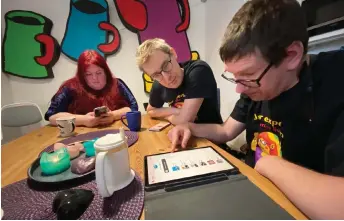  ?? — AFP photos by Viken Kantarci ?? Therese Wappsell (left), a ‘DigiVi’ user, meets to discuss about how to improve the platform with Magnus Linden (centre), one of it’s project managers, at a cafe in Uppsala, Sweden.