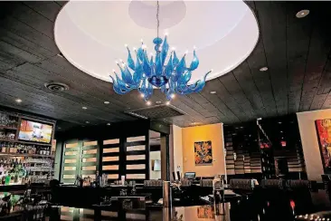  ?? [PHOTOS BY BRYAN TERRY, THE OKLAHOMAN] ?? The dramatic Omega Bar inside MMR Prime Steakhouse stands beneath a work of original blown glass art by Dale Chihuly.