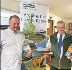  ??  ?? Newly-elected chairman Duncan McAllister (left) and his predecesso­r John Dickson, laden with Argyll and the Isles gifts.