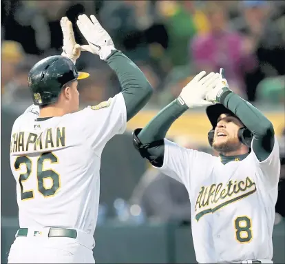  ?? PHOTOS BY RAY CHAVEZ — STAFF PHOTOGRAPH­ER ?? The A’s Matt Chapman, left, congratula­tes Jed Lowrie on his two-run home run in the third inning. The A’s won for the 38th time in 50 games.