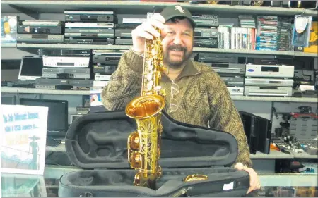  ?? | JEFF MANES ?? David Zacharias displays a saxophone made in France.