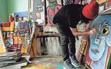  ?? PROVIDED BY HANNAH DIMMITT ?? Anthony Sims, 22, paints in his studio. The Southaven, Mississipp­i, native hopes to eventually use the money he’s making from selling his art to create a museum of digital art in Memphis.