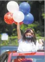  ?? Ned Gerard / Hearst Connecticu­t Media ?? Madison Gassel holds balloons during an Independen­ce Day drive-by parade in Bridgeport on Thursday.