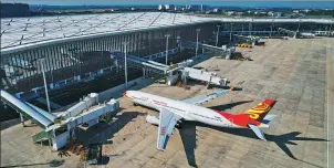  ?? YANG GUANYU / XINHUA ?? A Hainan Airlines passenger aircraft is seen docking at Haikou Meilan Internatio­nal Airport in November.