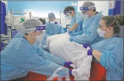  ?? (File Photo/AP/Kirsty Wiggleswor­th) ?? Critical Care staff move a covid-19 patient in January on the Christine Brown ward at King’s College Hospital in London.