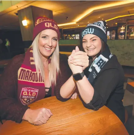  ?? Picture: MIKE BATTERHAM ?? Flatmates Melissa Galletly (left) and Brittany Etienne agree to disagree over Origin at The Star last night.