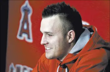  ?? CHRIS CARLSON/THE ASSOCIATED PRESS ?? No longer sporting his usual buzz cut, two-time American League MVP Mike Trout speaks on the first day of the Los Angeles Angels’ full-squad spring training Saturday.