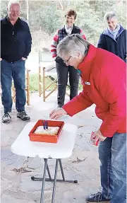  ??  ?? Drouin Uniting Church members Mavis Robson and Jan Stone celebrate the 43rd anniversar­y of the church.
Jean Thorpe lights the candles on a cake made to celebrate the occasion.