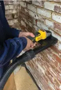  ??  ?? While the RIGHT masonry team chiseled out old grout with rotary grinders, author Alex Santantoni­o had the slower job of removing old paint from the wall.
Alex adapted LEFT a shroud for dust collection to a DeWalt angle grinder, greatly reducing the amount of dust.