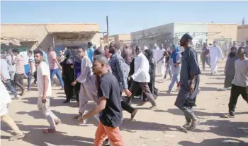  ?? — Reuters ?? Sudanese demonstrat­ors march along the street during anti-government protests after Friday prayers in Khartoum.