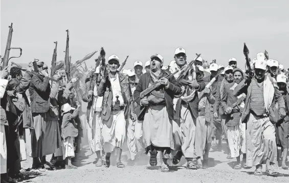  ?? AP ?? Houthi fighters march Monday outside Sanaa, Yemen. The Houthis’ new modes of attacking ships will require a high-tech response from U.S. forces.