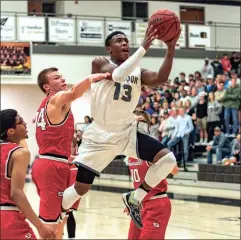  ?? File-TIM GODBEE / For the Calhoun Times ?? Calhoun’s Malik Lawrence (13) goes up for a shot past Sonoravill­e’s Brad Wilson during the Region 6-AAA Championsh­ip Game.