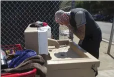  ??  ?? In this Sept. 5 photo, Jaime Lynn Hines washes his hands and face at one of the hand washing stations installed by the county in an attempt to stop the spread of Hepatitis A in San Diego. JOHN GIBBINS/THE SAN DIEGO UNION-TRIBUNE VIA AP