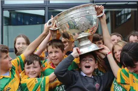  ??  ?? Primary pupils from Ballycloug­h who were delighted to meet Sam McGuire at the official opening of the playing pitch at Colaiste Mhuire in Buttevant.