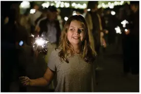  ?? STEPHEN SPILLMAN FOR AMERICAN-STATESMAN PHOTOS ?? Loretta Stiles, 12, attends the ceremony celebratin­g the restoratio­n of two gateposts on William Barton Drive, leading into Barton Springs Pool.