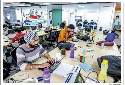  ?? Bloomberg News ?? Employees work on laptops in 2017 at the Flipkart Online Services headquarte­rs in Bengaluru, India. “Walmart’s and Flipkart’s commitment to India is deep and long-term,” one Walmart executive says.