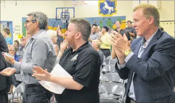  ??  ?? Stratford Mayor David Dunphy, right, and Coun. Keith MacLean, left, along with Jonathan Dunphy, applaud the announceme­nt that the Public Schools Branch will be moving forward with a recommenda­tion for building a secondary school in Stratford.