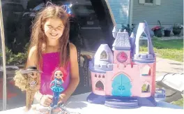  ?? SUE ELLEN ROSS/POST-TRIBUNE ?? Jalyne Shaver, 9, set up a colorful table of her unwanted items to sell at the Community-Wide Yard Sale.