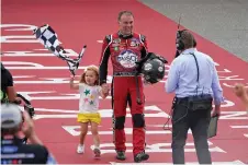  ?? PAUL SANCYA ASSOCIATED PRESS ?? Kevin Harvick celebrates with his daughter Piper on Sunday after winning the NASCAR Cup Series race at the Michigan Internatio­nal Speedway in Brooklyn, Mich.