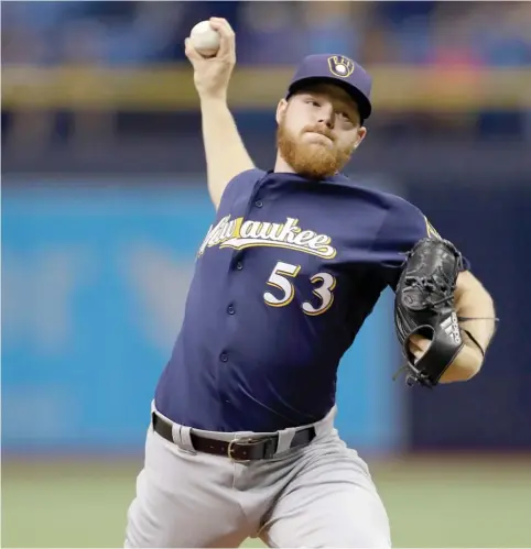  ?? (Photo by Chris O'Meara, AP) ?? Former Mississipp­i State pitcher Brandon Woodruff works against the Tampa Bay Rays in his major league debut with the Milwaukee Brewers on Friday night. Woodruff pitched 6 1/3 shutout innings and got the win as the Brewers defeated the Rays 2-0.