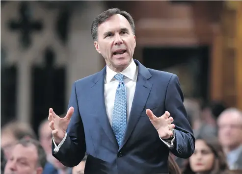  ?? JUSTIN TANG / THE CANADIAN PRESS ?? Finance Minister Bill Morneau, who faced attacks in the House of Commons on Monday, rises during Question Period.