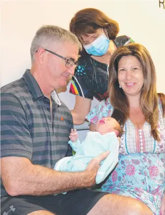  ??  ?? Darwin couple Nigel and Artemis Doyle with their newborn son, Nick, and RDH lactation consultant and midwife Louise Prescott. Picture: Supplied