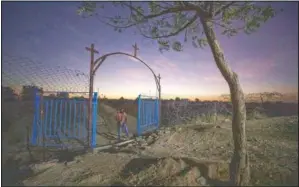  ??  ?? A gate stands open at the church where Tigrayan refugee Abraha Gebremaria­m prays in Hamdayet. More than 62,000 refugees from Ethiopia’s embattled Tigray region are in Sudan.