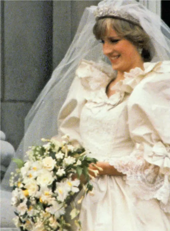  ??  ?? Welcome to the family: A delighted Queen joins the newlywed Diana on the balcony at Buckingham Palace