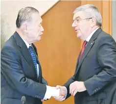  ?? — AFP photo ?? Thomas Bach (right) shakes hands with Tokyo 2020 president Yoshiro Mori at the end of the opening plenary session of the IOC Coordinati­on Commission in Tokyo.