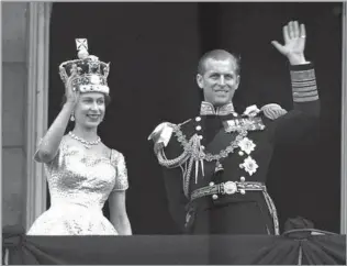  ?? Leslie Priest Associated Press ?? MARRIED TO THE MONARCH Queen Elizabeth II and her husband, Prince Philip, Duke of Edinburgh, wave from the balcony of Buckingham Palace after the 25-year-old queen’s coronation on June 2, 1953.